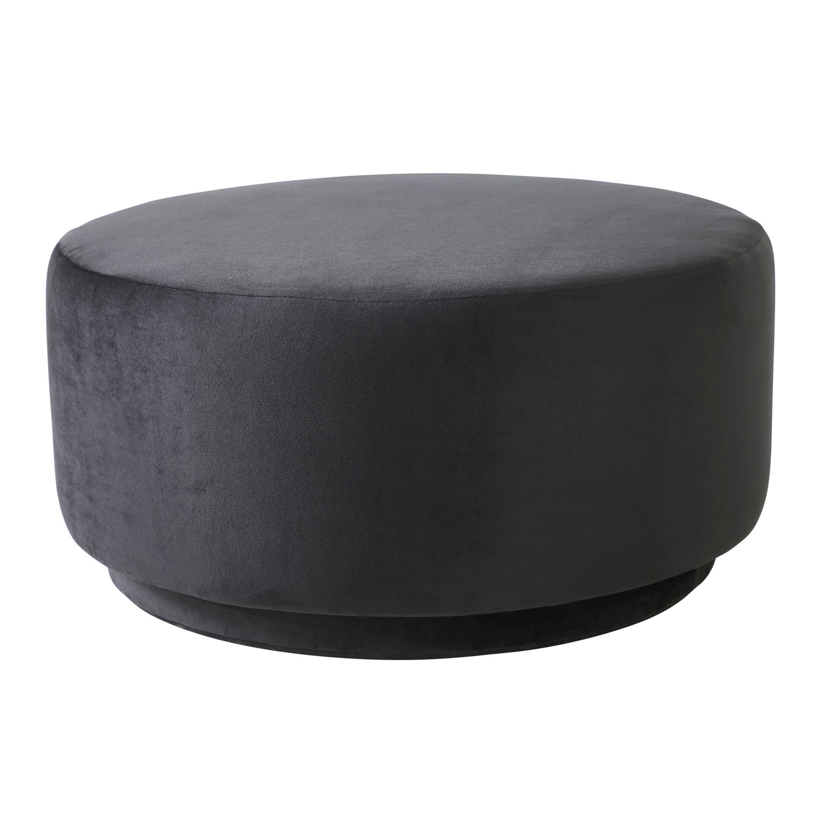 Colum Ottoman in dark gray velvet, round shape with smooth surface, angled view.