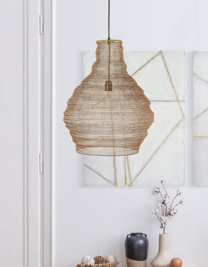 Gere Ceiling Fixture, a woven rattan chandelier in natural tones, hanging against a light wall with abstract art.