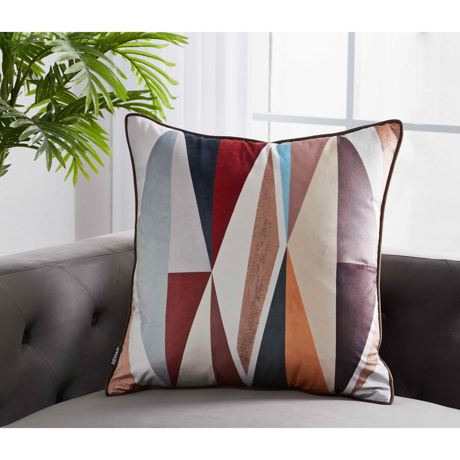 Michel Indoor Pillow featuring geometric patterns in red, blue, and beige tones.
