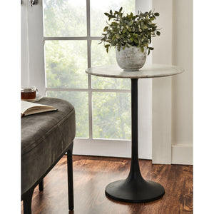 Mortain Table styled with a potted plant and a book, next to a window
