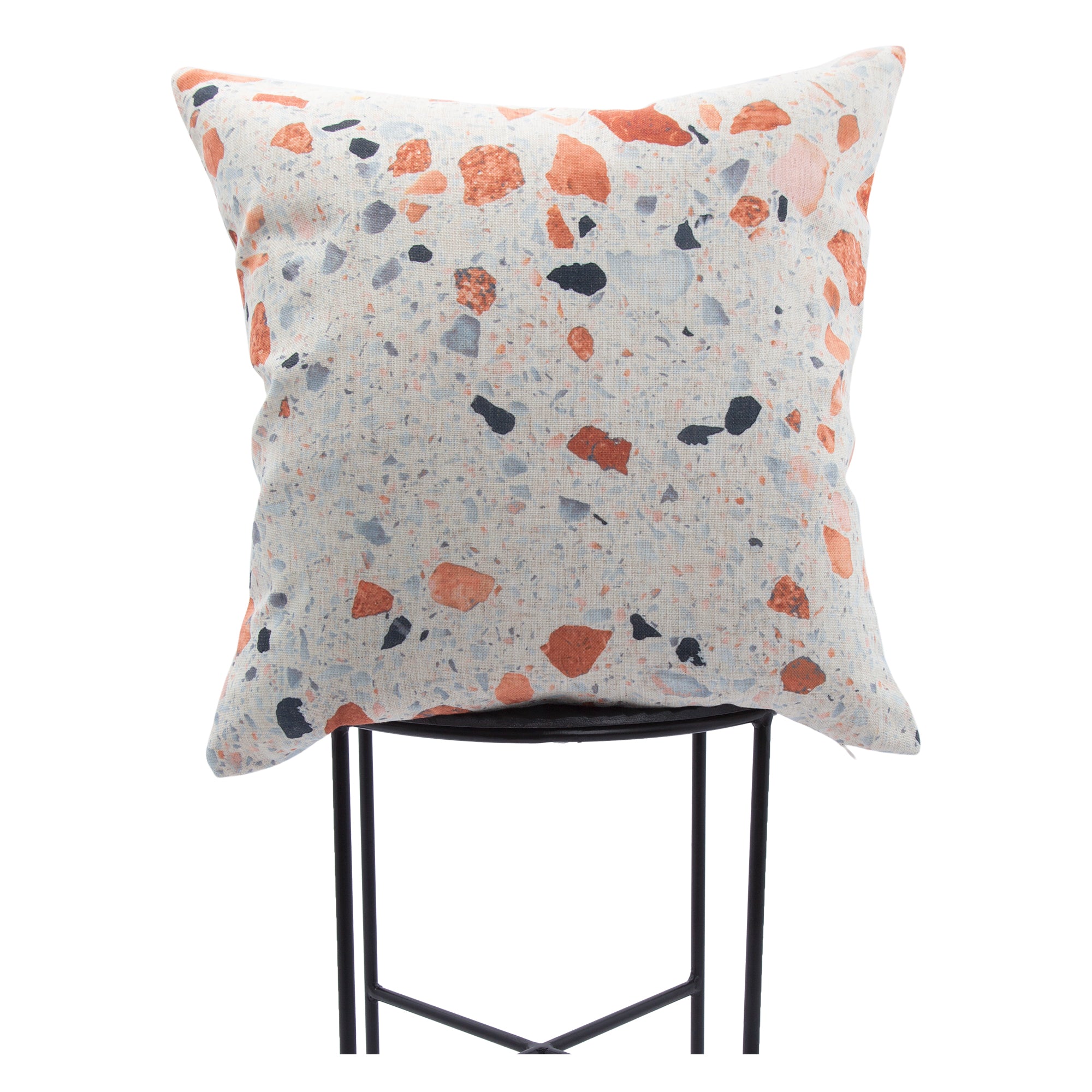 Castelo Indoor Pillow displayed on a black metal chair, showcasing a colorful speckled design.
