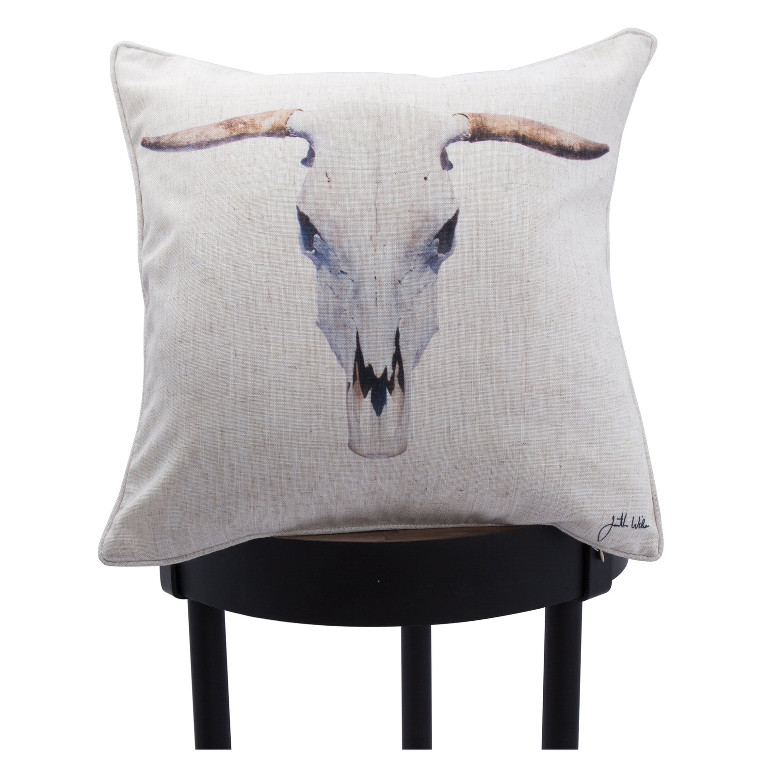Elgin pillow featuring a bull skull design on a beige linen background.