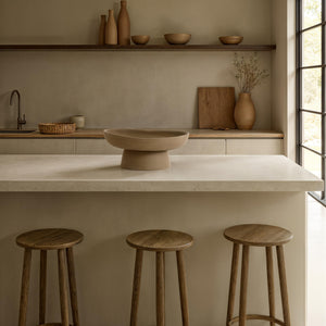 Blouin Vase by Renwil on a kitchen island, surrounded by wooden stools and minimalist decor.