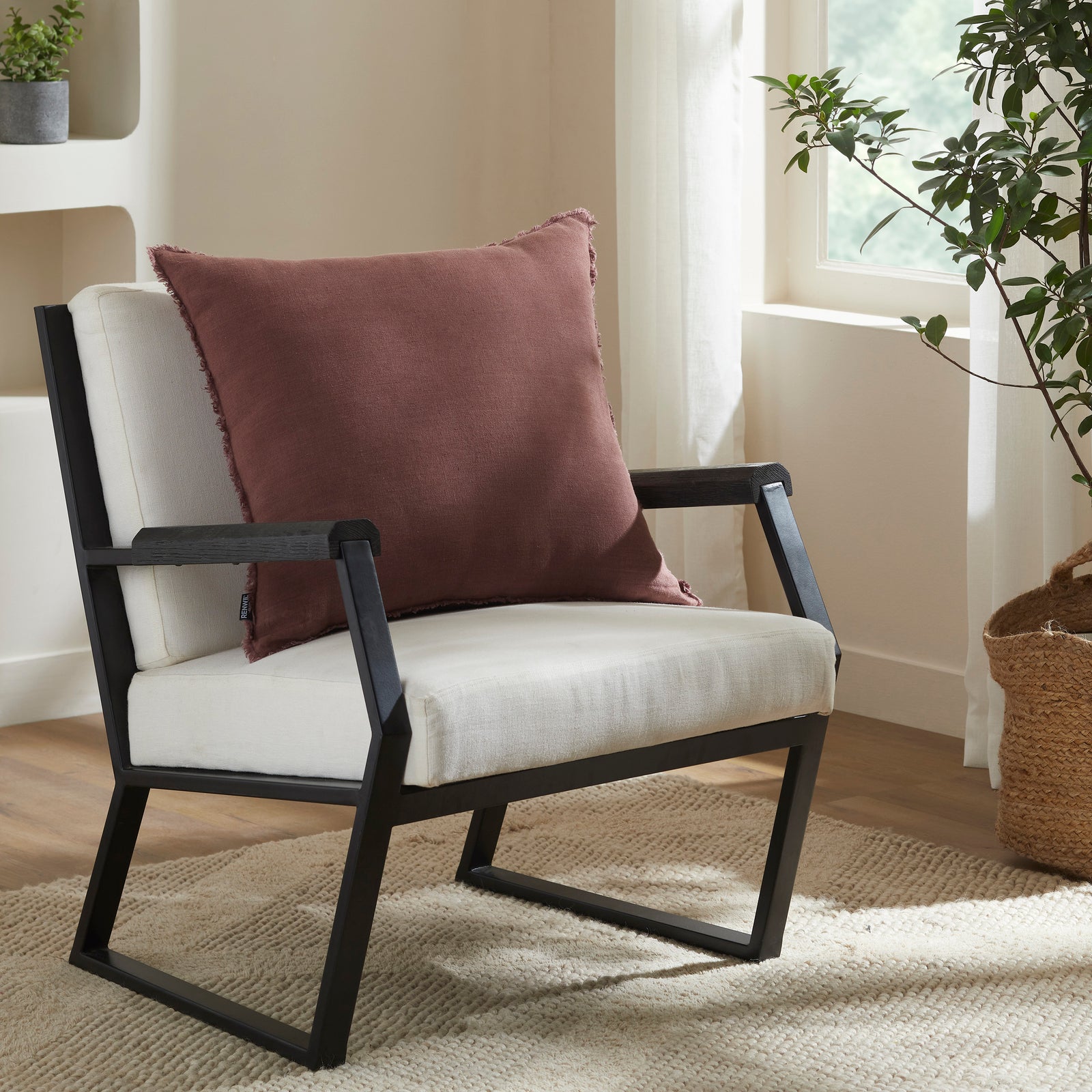 Pan Indoor Pillow in rich brown color with frayed edges, showcasing soft fabric texture.