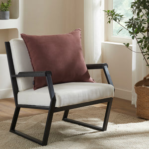 Pan Indoor Pillow in brown placed on a modern black chair, surrounded by natural light.