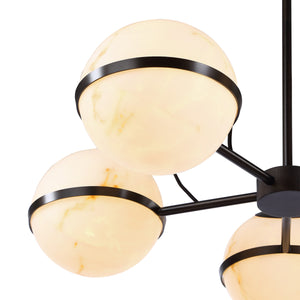 Roca ceiling fixture showcasing three lit white marble globes with black metal rings, close-up view.