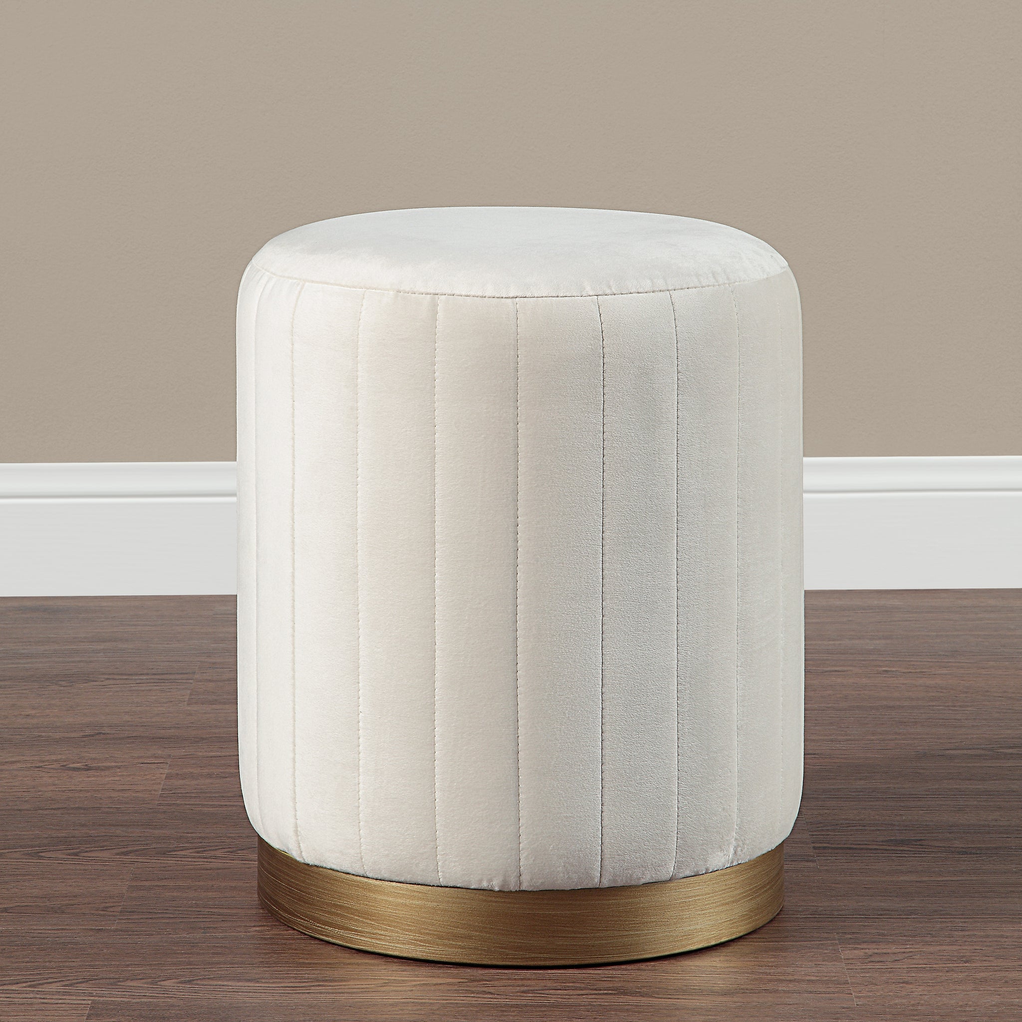 Baylor Ottoman in a room setting with beige wall and wooden floor