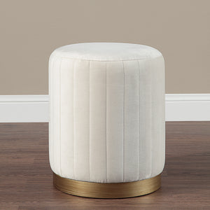Baylor Ottoman in a room setting with beige wall and wooden floor