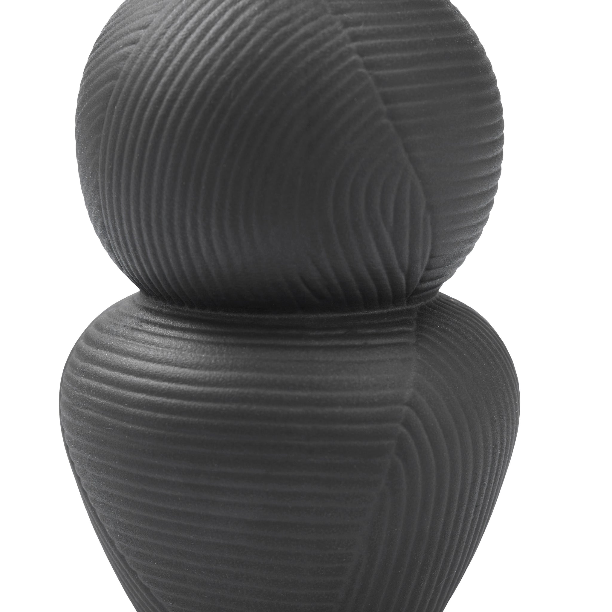 Close-up of the Icarus Vase's lower section, showcasing its unique shape and texture.