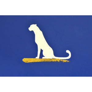 Makalu Wall Art displaying a sitting white dog silhouette against a blue background with gold highlights