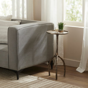 Dunn Side Table placed beside a gray sofa, styled with a small plant and candle.