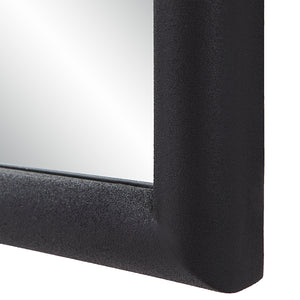 Close-up of Dovima Wall Mirror's black frame highlighting its textured surface.