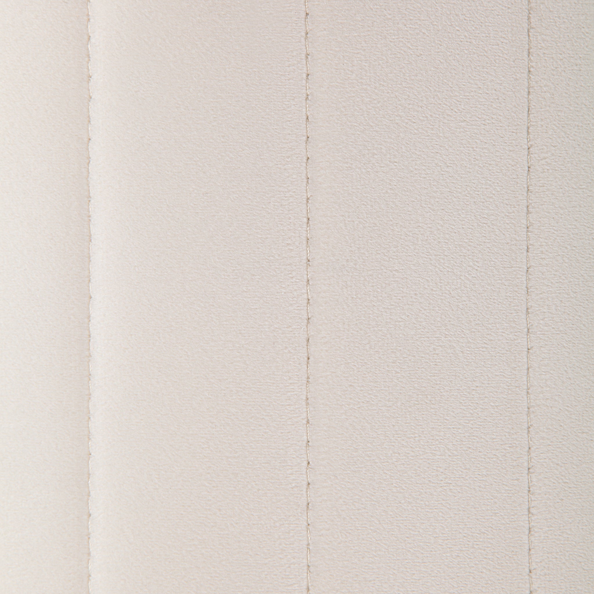 Detailed view of Baylor Ottoman's beige fabric with vertical seams