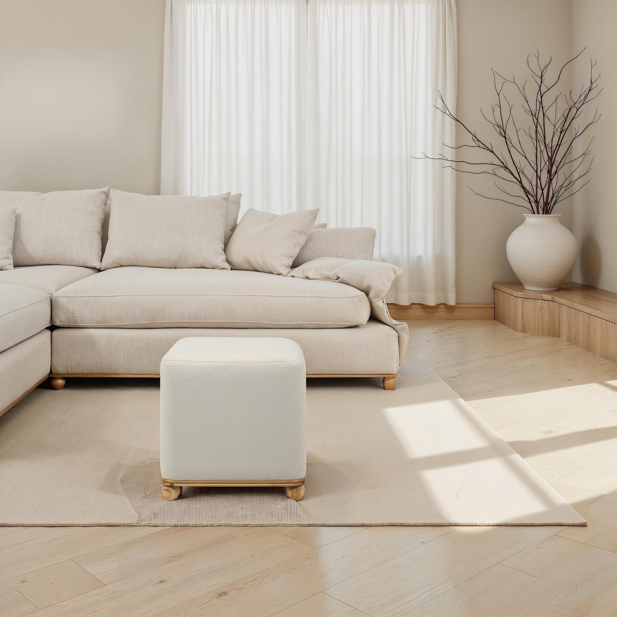 Sines Ottoman in a modern living room setting with beige sofa and natural light