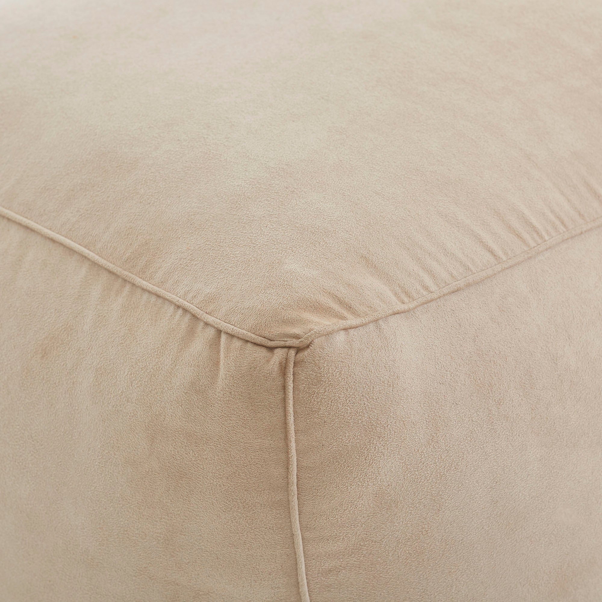 Detailed view of Bundle Pouf in soft beige, emphasizing the smooth fabric and corner stitching.