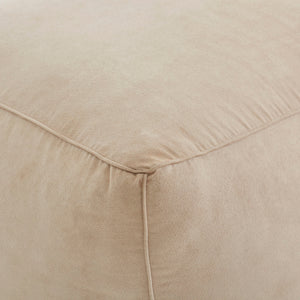 Detailed view of Bundle Pouf in soft beige, emphasizing the smooth fabric and corner stitching.