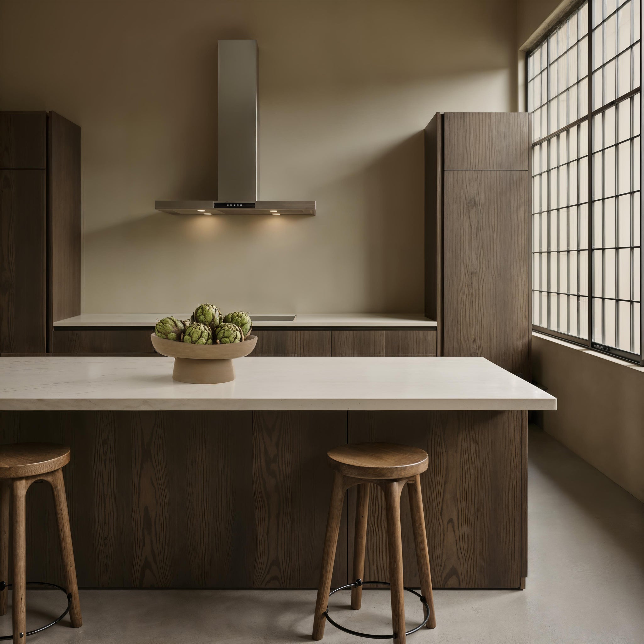 Blouin Vase by Renwil displayed in a modern kitchen, filled with artichokes on a marble countertop.
