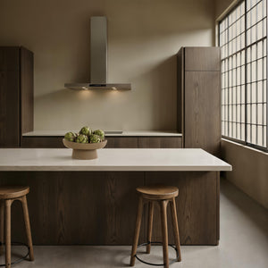 Blouin Vase by Renwil displayed in a modern kitchen, filled with artichokes on a marble countertop.