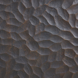 Close-up of Jean Cabinet's textured dark wood surface with intricate patterns