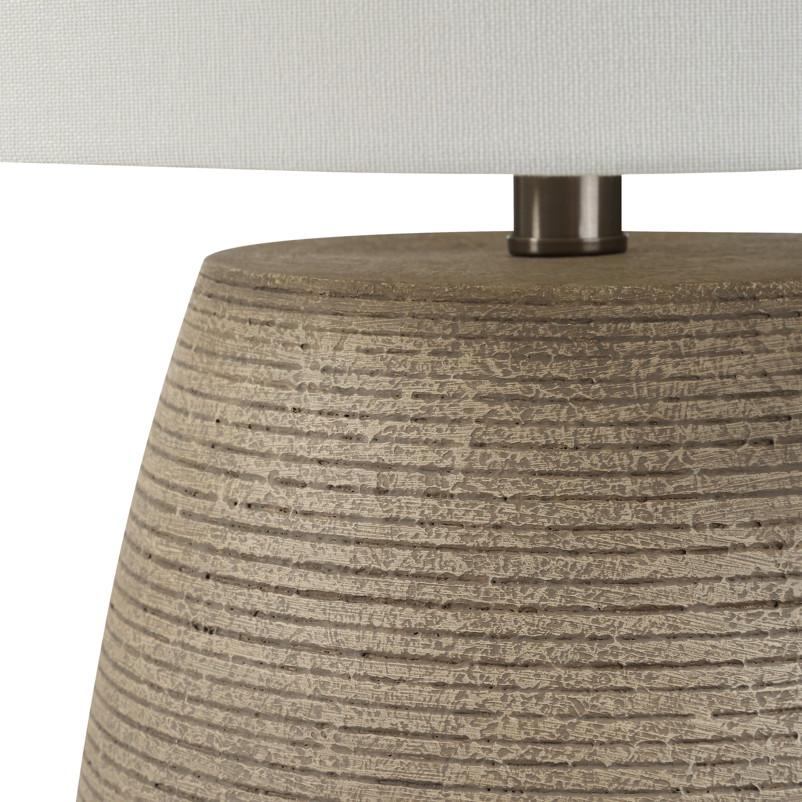 Optima table lamp with a textured beige base and white fabric shade.