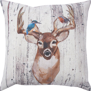 Montana indoor pillow featuring a deer with birds on antlers, rustic design on a light background.