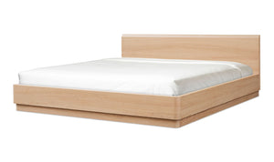 Wooden bed frame with white mattress on a white background