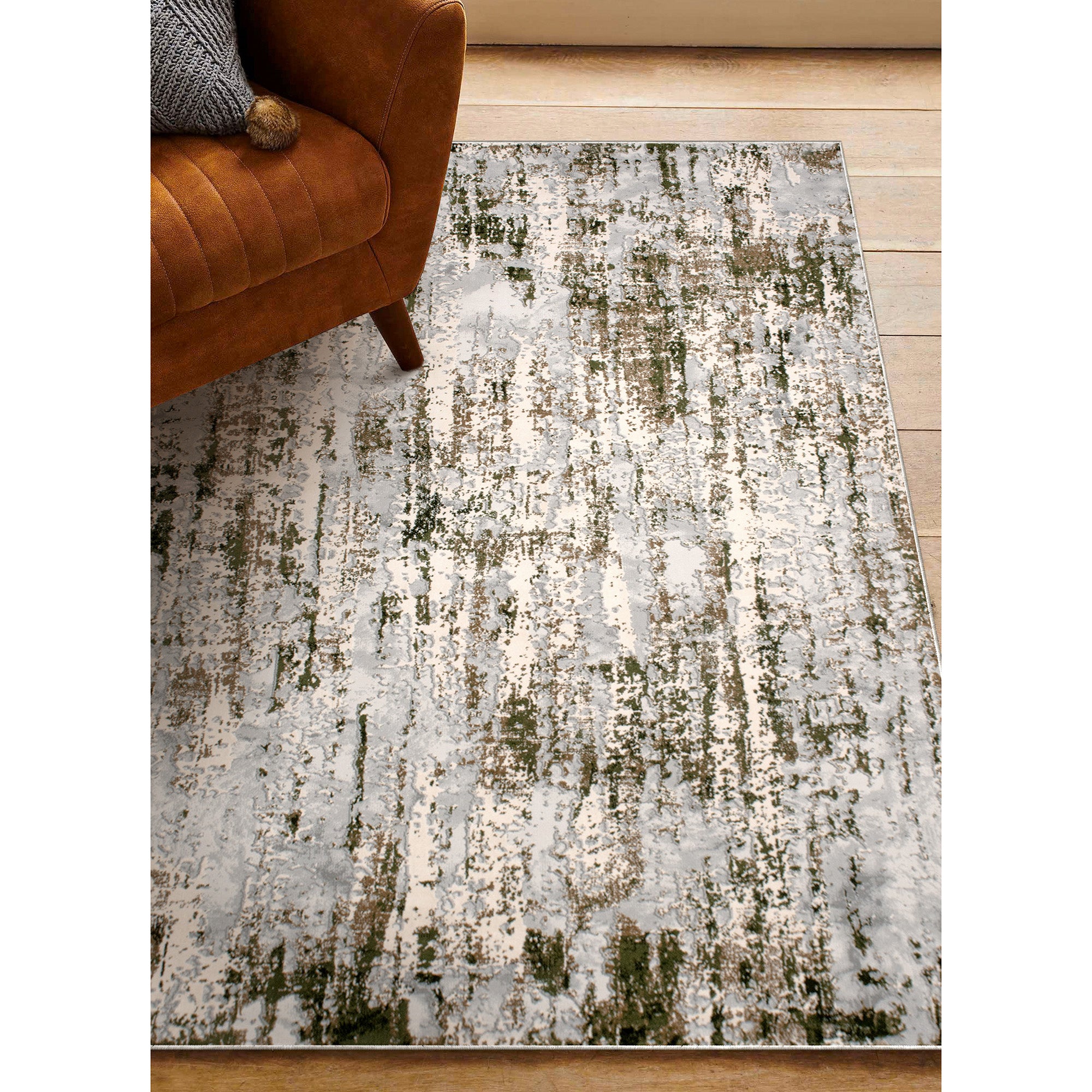 Ariella Indoor Rug in a living space, paired with a brown sofa, showcasing its gray and green design.