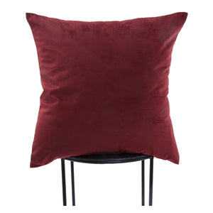 Scarlet pillow in deep red, displayed upright on a black metal chair.
