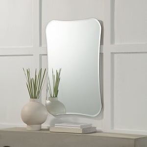 Kalmia Wall Mirror displayed above a modern vase and books on a shelf