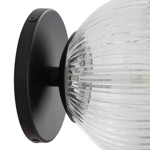 Brian Wall Sconce featuring a close-up view of the clear ribbed glass globe and black metal mount.